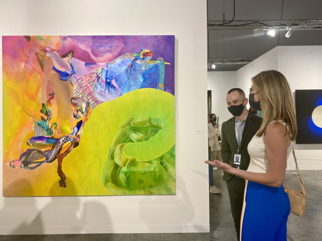 Sarah Arison and Joshua Friedman with a painting by Ilana Savdie from Los Angeles's Kohn Gallery at Art Basel Miami Beach. Arison bought a painting by the artist at the gallery's current solo show. Photo by Sarah Cascone. 