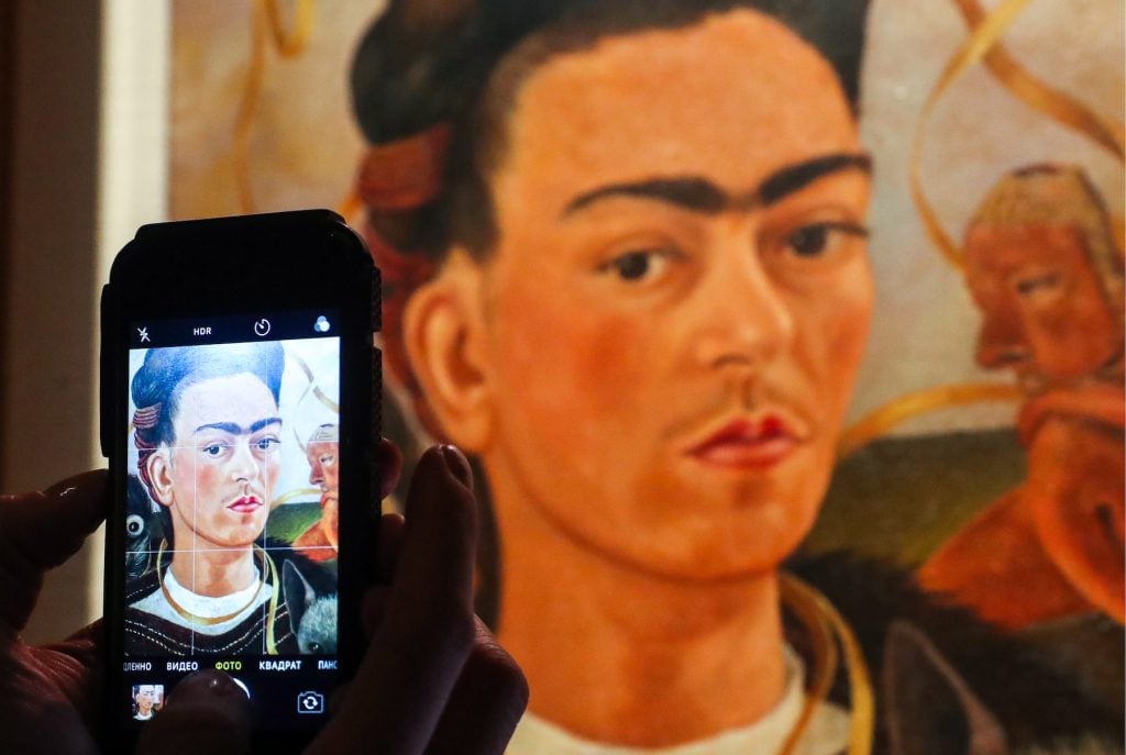Self-Portrait With Monkey, a 1945 painting by Frida Kahlo, on display at an exhibition titled 
