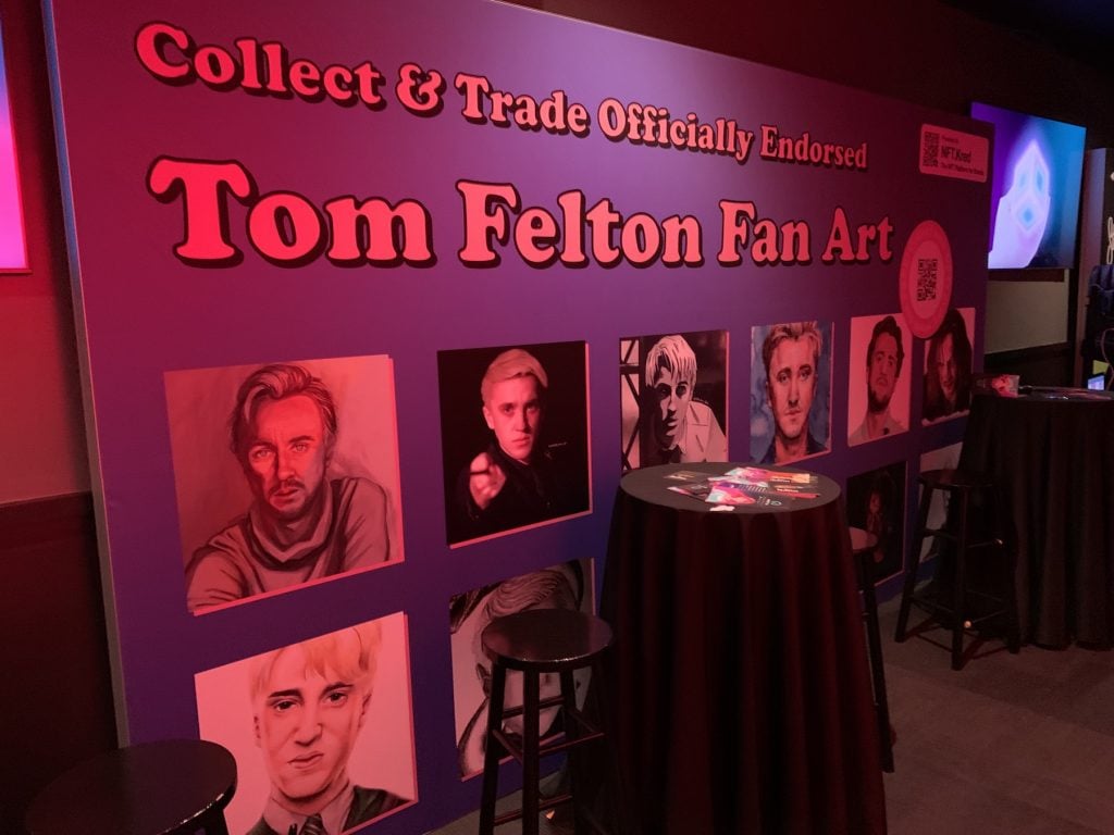 Banner advertising Tom Felton fan art at NFT.NYC. Photo by Ben Davis.