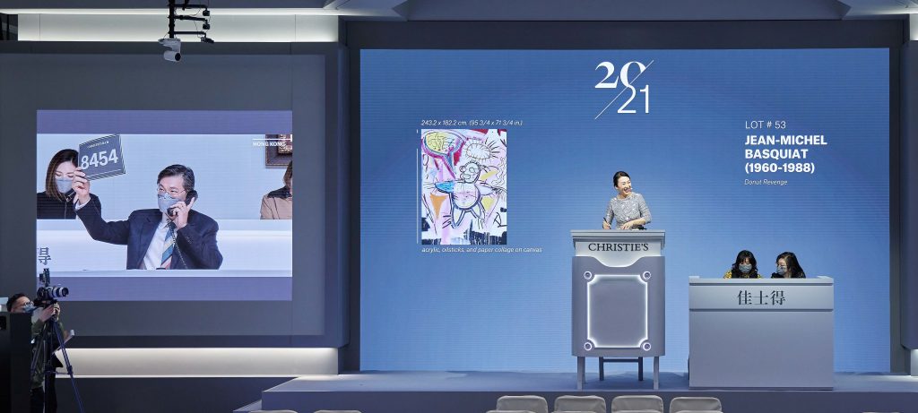 Auctioneer Elaine Kwok sold Jean-Michel Basquiat's Donut Revenge to a phone bidder represented by Eric Chang, Christie's chair of modern and contemporary art in Hong Kong. Courtesy of Christie's.