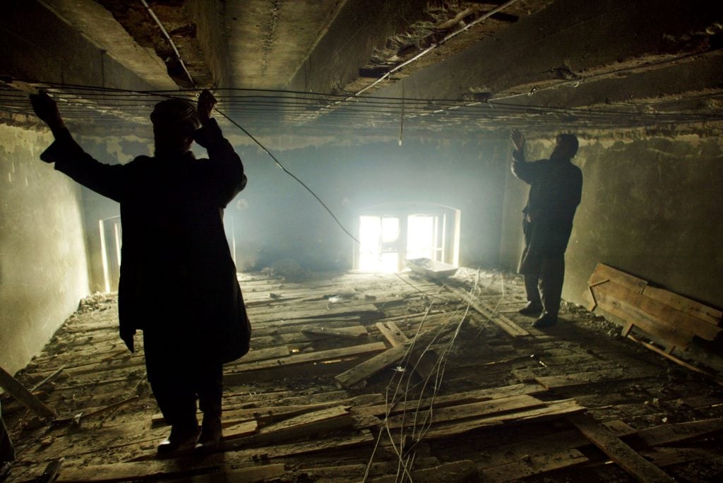 Afghan construction workers put a new ceiling in one of the rooms at the Kabul Museum on February 18, 2003 in Kabul, Afghanistan. The museum, which was extensively damaged through the previous regimes, is now being renovated with the help of the British Museum, UNESCO, and the Greek government. The renovations include a special conservation workshop for restoration of the many broken artifacts. Photo by Paula Bronstein/Getty Images.