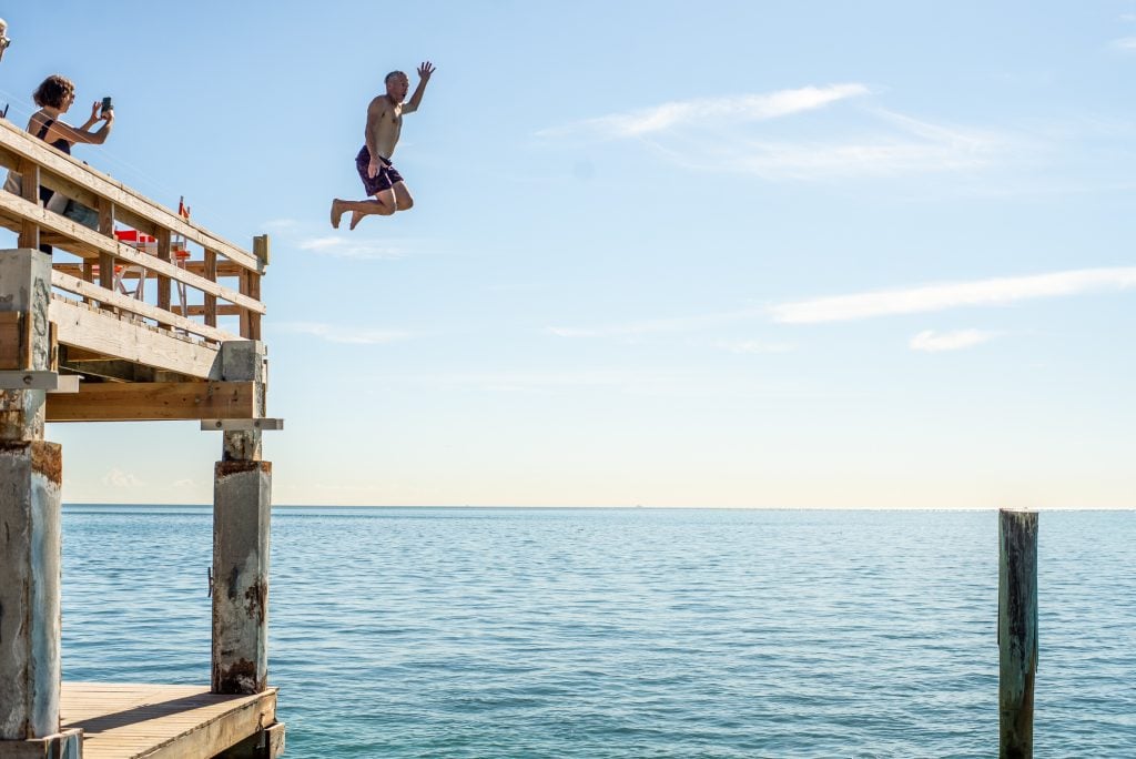 Bill Powers takes a plunge during his show out at Stiltsville in Biscayne Bay. Courtesy Justin Namon/ra-haus Fotografie.