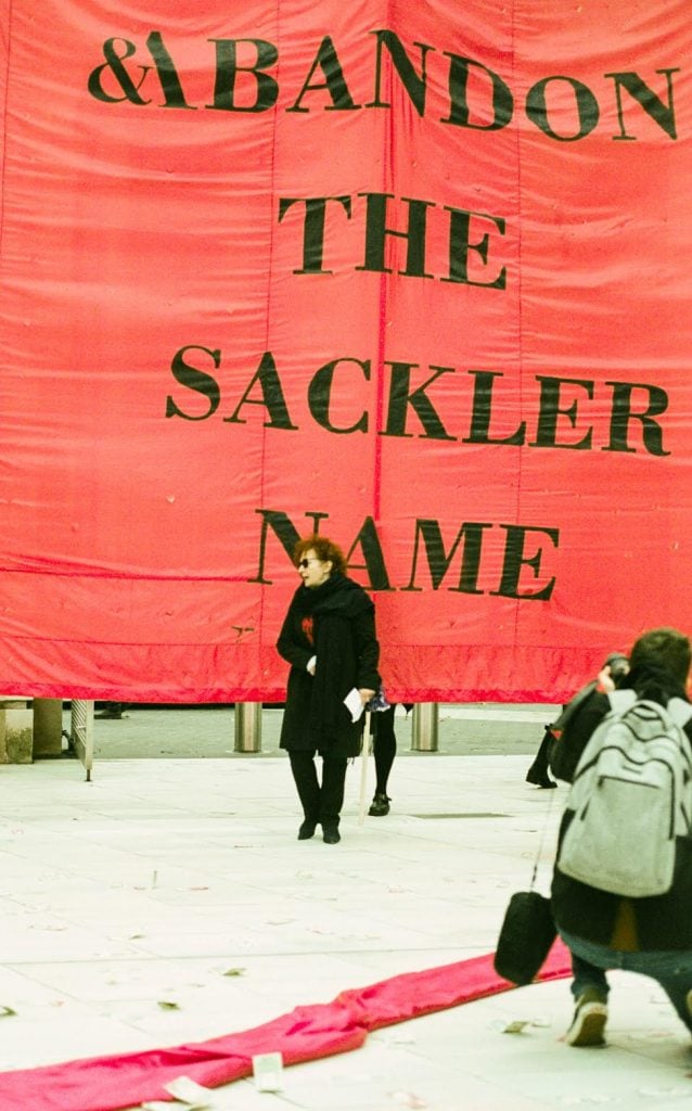 Nan Goldin protesting with Sackler P.A.I.N. at the Victoria and Albert Museum in London in 2019. Photo by Lottie Maher, courtesy of Sackler P.A.I.N.