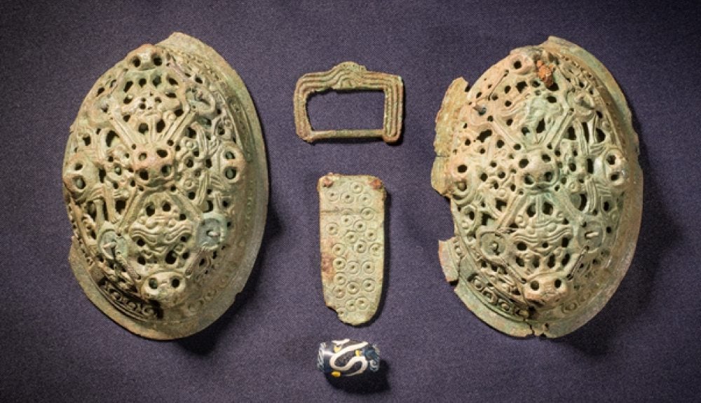 Two brooches, a belt buckle, and a glass bead discovered on the Isle of Man in 2018. Courtesy of the Manx Museum.