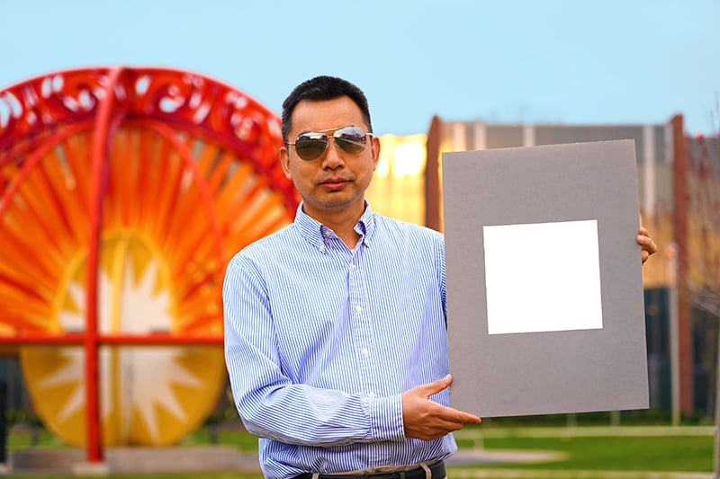 Xiulin Ruan, a Purdue University professor of mechanical engineering, holds up his lab’s sample of the whitest paint on record. Photo by Jared Pike, courtesy Purdue University.