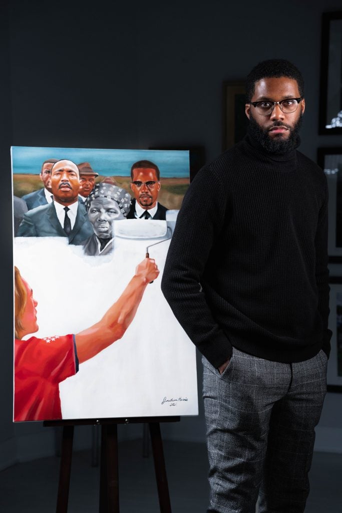 Jonathan Harris with his painting Critical Race Theory (2021). Photo courtesy of Jonathan Harris.