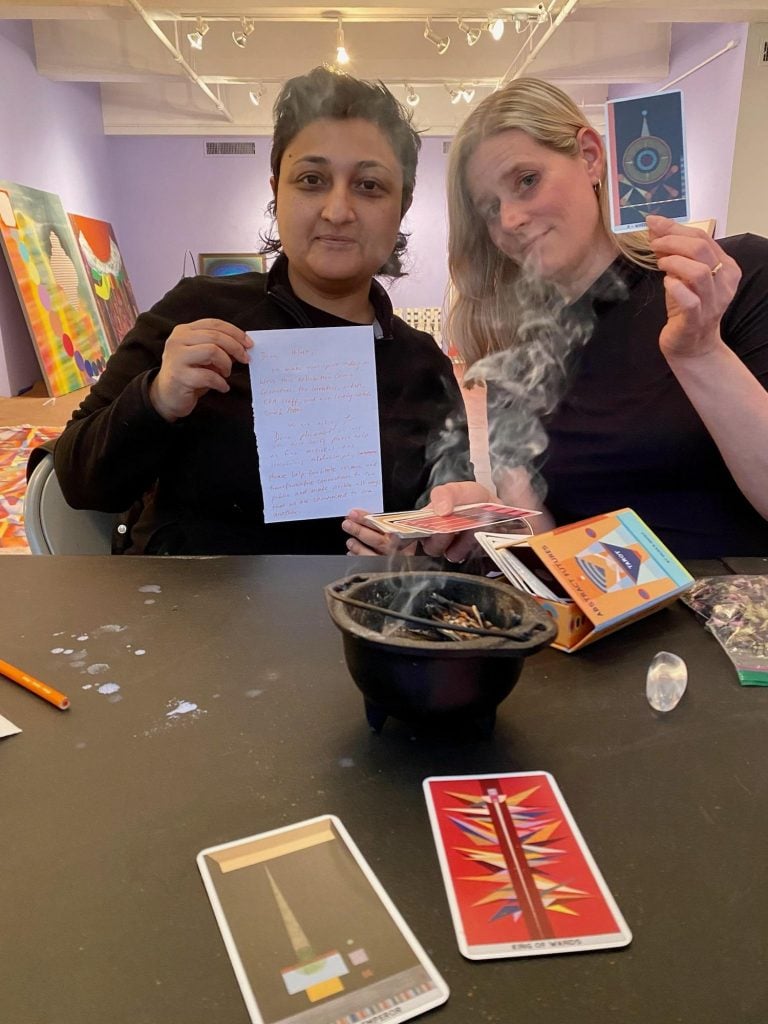 Cosmic Geometries curators Sharmistha Ray and Dannielle Tegeder divining the installation of the exhibition under the guidance of tarot reader and witch Sarah Potter. Photo courtesy of the EFA Project Space, New York. 