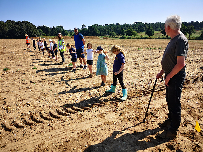 Volunteers from Rendlesham Primary School with professor Tom Williamson during excavations at Rendlesham. Photo ⒸSuffolk County Council.