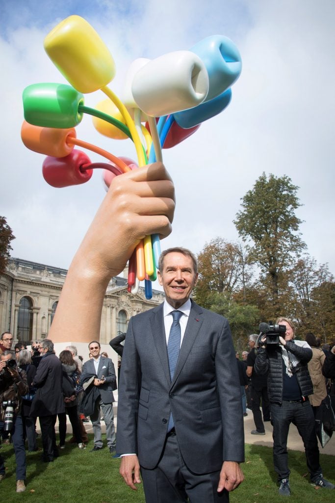 Jeff Koons poses in front of his creation entitled "Tulips bouquet" next to the Grand Palais on October 04, 2019, in Paris, France. Photo by Stephane Cardinale - Corbis/Corbis via Getty Images)