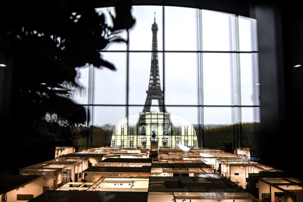 Booths are seen in front of the Eiffel Tower during the Contemporary Art International Fair (FIAC), at the temporary Grand Palais in Paris on October 21, 2021. Photo by Christophe Archambault/AFP via Getty Images.
