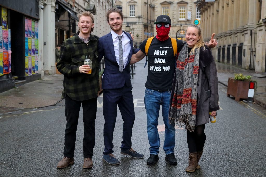 Milo Ponsford, Sage Willoughby, Jake Skuse and Rhian Graham, collectively known as the Colston Four, pose for a photograph outside Bristol Crown Court where they are being tried in connection with the toppling of a statue of 17th century slave trader Edward Colston during global Black Lives Matter protests in 2020. Photo by Geoff Caddick/AFP via Getty Images.