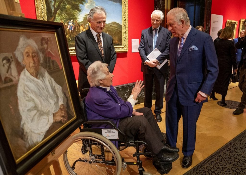 Britain's Prince Charles, Prince of Wales (R) talks with Holocaust survivor Anita Laskar-Wallfisch, (C) as she sits alongside a portrait of herself, painted by Artist Peter Kuhfeld, and commissioned by The Prince of Wales to pay tribute to Holocaust survivors , during a display entitled 'Seven Portraits: Surviving the Holocaust' at The Queen's Gallery in Buckingham Palace, London on January 24, 2022. - The special display Seven Portraits: Surviving the Holocaust at The Queen's Gallery, Buckingham Palace has been commissioned by HRH The Prince of Wales to pay tribute to the stories of seven remarkable Holocaust survivors, each of whom has in recent years been honored for services to Holocaust awareness and education.  - RESTRICTED TO EDITORIAL USE - MANDATORY MENTION OF THE ARTIST UPON PUBLICATION - TO ILLUSTRATE THE EVENT AS SPECIFIED IN THE CAPTION (Photo by ARTHUR EDWARDS / POOL / AFP) / RESTRICTED TO EDITORIAL USE - MANDATORY OF THE MANDATORY ISTIC EVENT AS SPECIFIED IN THE CAPTION / RESTRICTED TO EDITORIAL USE - MANDATORY MENTION OF THE ARTIST UPON PUBLICATION - TO ILLUSTRATE THE EVENT AS SPECIFIED IN THE CAPTION (Photo by ARTHUR EDWARDS/POOL/AFP via Getty Images)