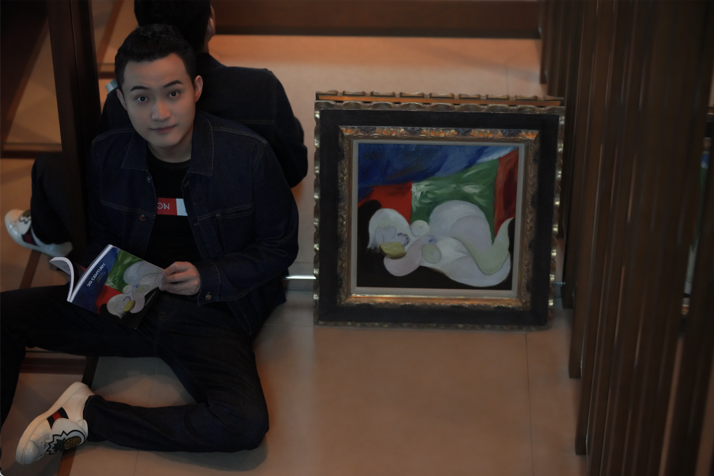 Tron founder Justin Sun with Pablo Picasso's Femme nue couchée au collier (Marie-Thérèse), 1932, which he purchased for $20 million at Christie's in 2021. Courtesy of APENFT Foundation.