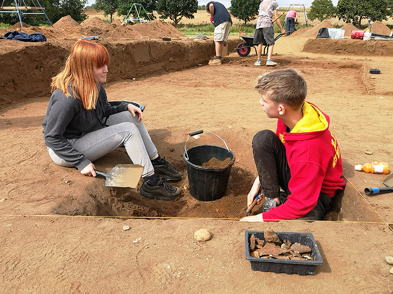 Volunteers from Suffolk Young Carers excavating the cellar of an Anglo-Saxon hut at Rendlesham. Photo ⒸSuffolk County Council.