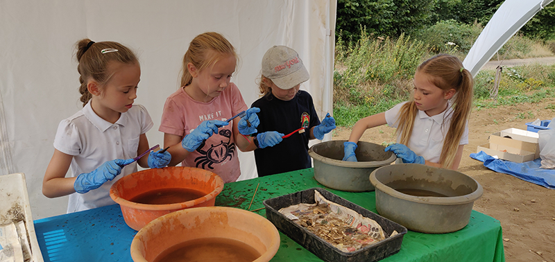 Volunteers from Rendlesham Primary School cleaning archaeological finds at Rendlesham. Photo ⒸSuffolk County Council.