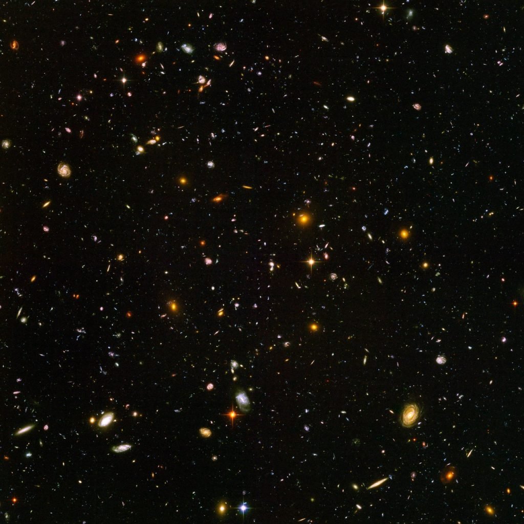 This view of nearly 10,000 galaxies is called the Hubble Ultra Deep Field. The snapshot includes galaxies of various ages, sizes, shapes, and colors. The smallest, reddest galaxies, about 100, may be among the most distant known, existing when the universe was just 800 million years old. The nearest galaxies—the larger, brighter, well-defined spirals and ellipticals—thrived about one billion years ago, when the cosmos was 13 billion years old. The image required 800 exposures taken over the course of 400 Hubble orbits around Earth, pointed at a patch of sky where astronomers had not previously observed any stars. The total amount of exposure time was 11.3 days, taken between September 24, 2003 and January 16, 2004. Courtesy of NASA, ESA, and S. Beckwith (STScI) and the HUDF Team, Creative Commons <a href=http://creativecommons.org/licenses/by/4.0/ target="_blank" rel="noopener">Attribution 4.0 International</a> license.