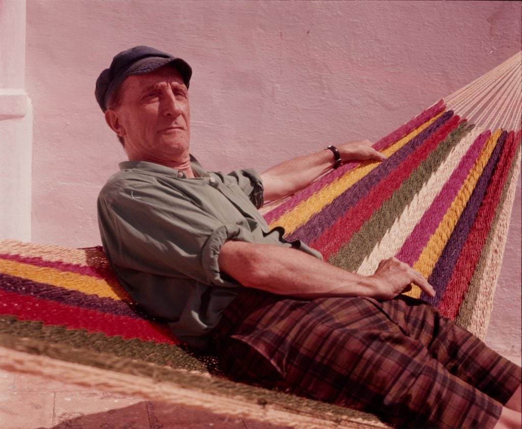 Picture by Man Ray of Marcel Duchamp in a hammock in his residency in Cadaquès, Spain, 1965. Courtesy of the Man Ray Trust/Adagp, Paris © Centre Pompidou.