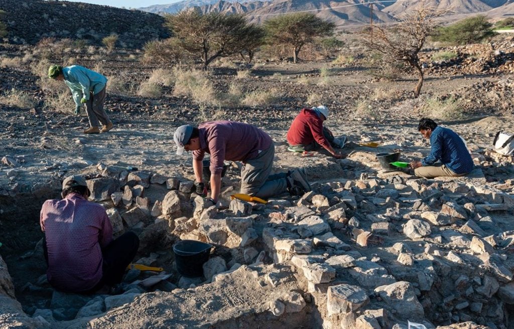 Archaeologists excavating a Bronze Age and Iron Age settlement near the village of Ayn Bani Saidah in Oman. Photo by J.Sliwa, courtesy of the Polish Centre of Mediterranean Archaeology.