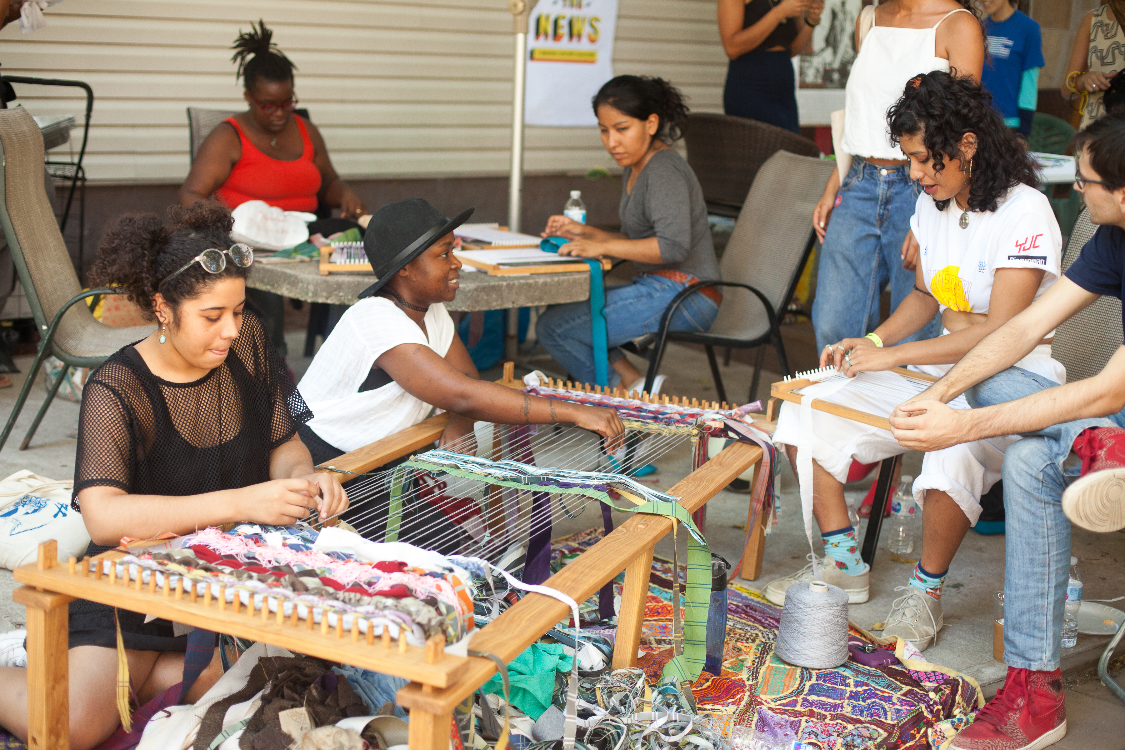 Community members participating in a weaving activity during one of The Laundromat Project's Field Days workshops in 2017. Courtesy of The Laundromat Project. Photo: Neha Gautam.