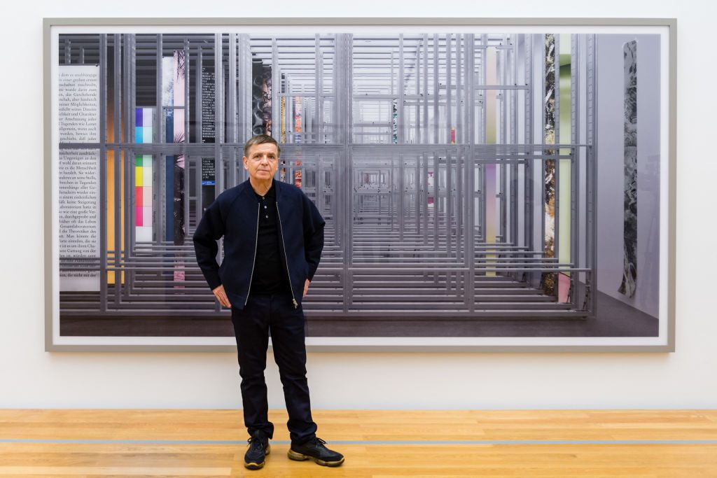 German photo artist Andreas Gursky poses in the front of the photographic work Lager (2014) in the exhibition "Andreas Gursky" at the Museum of Fine Arts Leipzig, in Leipzig eastern Germany on March 24, 2021. Photo by Jens Schlueter/AFP via Getty Images.