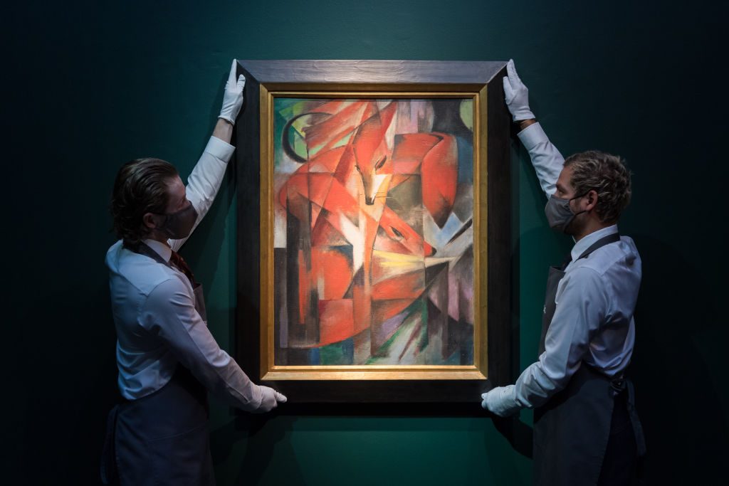 Staff members hold The Foxes(1913) by Franz Marc, during a photo call to present the centrepiece of the 20th / 21st Century: London Evening Sale taking place on 1st March at Christie's auction house on January 31, 2022 in London, England. Photo by Wiktor Szymanowicz/Future Publishing via Getty Images.