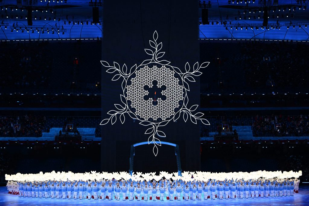 A giant snowflake sculpture with the Olympic flame at its center during the opening ceremony of the Beijing 2022 Winter Olympic Games, at the National Stadium, known as the Bird's Nest, in Beijing, on February 4, 2022. Photo by Manan Vatsyayana/AFP via Getty Images.