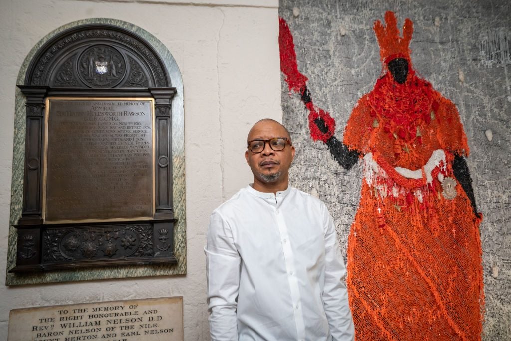 Artist Victor Ehikhamenor with his artwork Still Standing after its unveiling at St Paul's Cathedral, in London, which will be on display in the crypt until 14 May 2022. Picture date: Thursday February 17, 2022. Photo by Aaron Chown/PA Images via Getty Images.