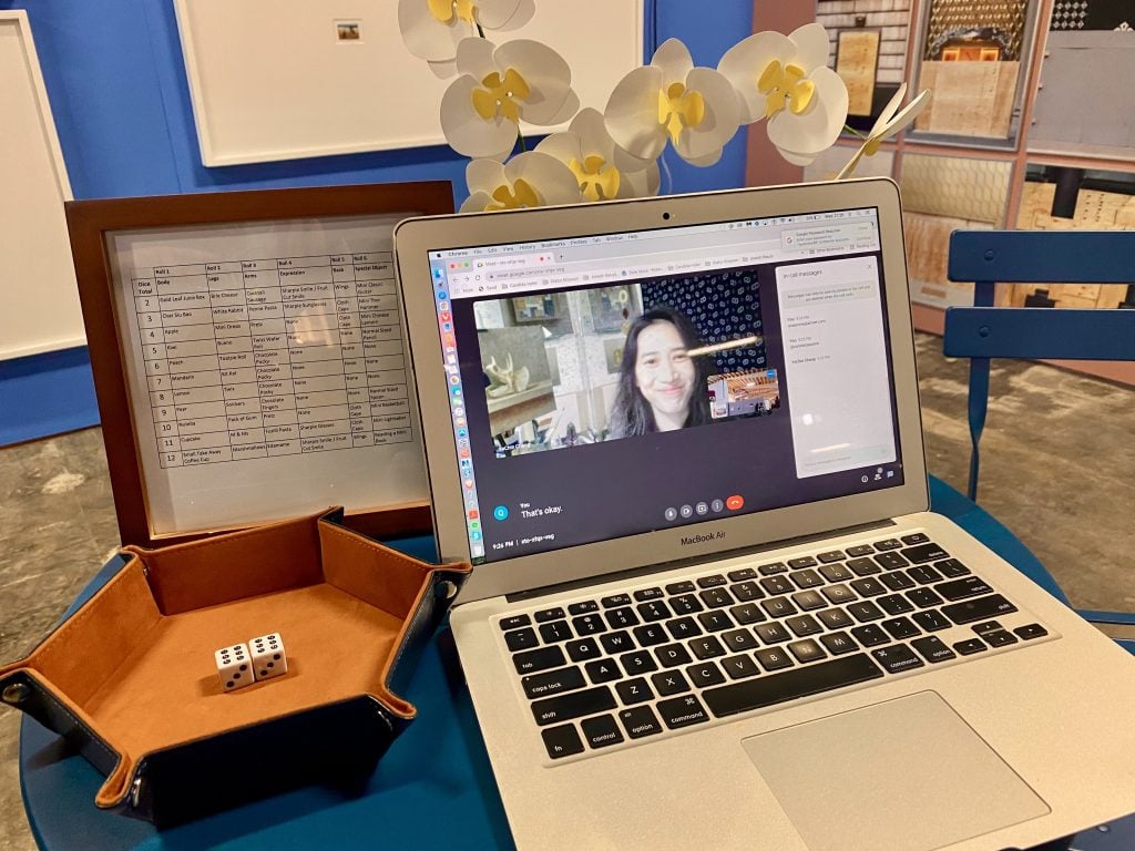 Ya Chin Chang video chatting from Hong Kong during the opening of Spring/Break Los Angeles 2022, where collectors could roll the dice to create a generative profile picture NFT and accompanying oil painting from her "Snackstalgia Buddy" series. Photo by Sarah Cascone.