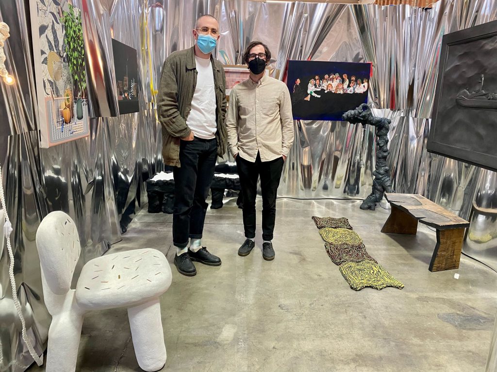 Artists and curators Patrick Geske and Cody Miner with their booth "Holy Crap" at Spring/Break Los Angeles 2022. Photo by Sarah Cascone. 