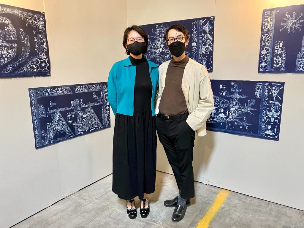 Artist duo Towers (Dione Lee and Ethan Sim) with their work in "odd souls fall madly/the Debris riffs endlessly/into the minor Gods" curated by Ankita Mukherji and Elisabeth Smolarz at Spring/Break Los Angeles 2022. Photo by Sarah Cascone. 