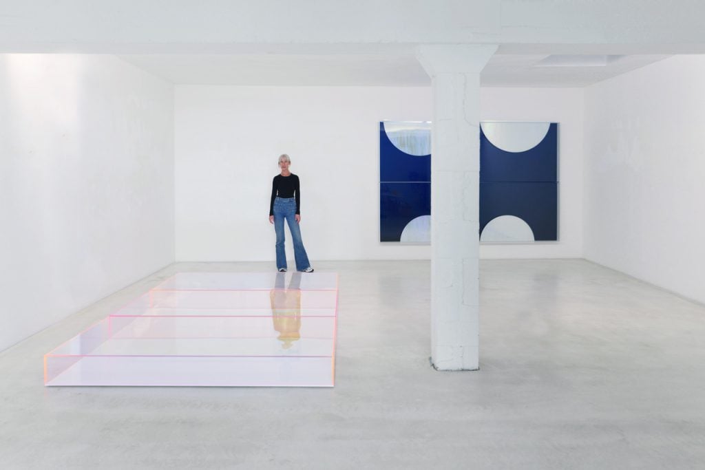 Regine Schumann with her works Colormirror Rainbow Twice Blue Ossenheim (2021) and Colormirror Moons No. 14(2021).