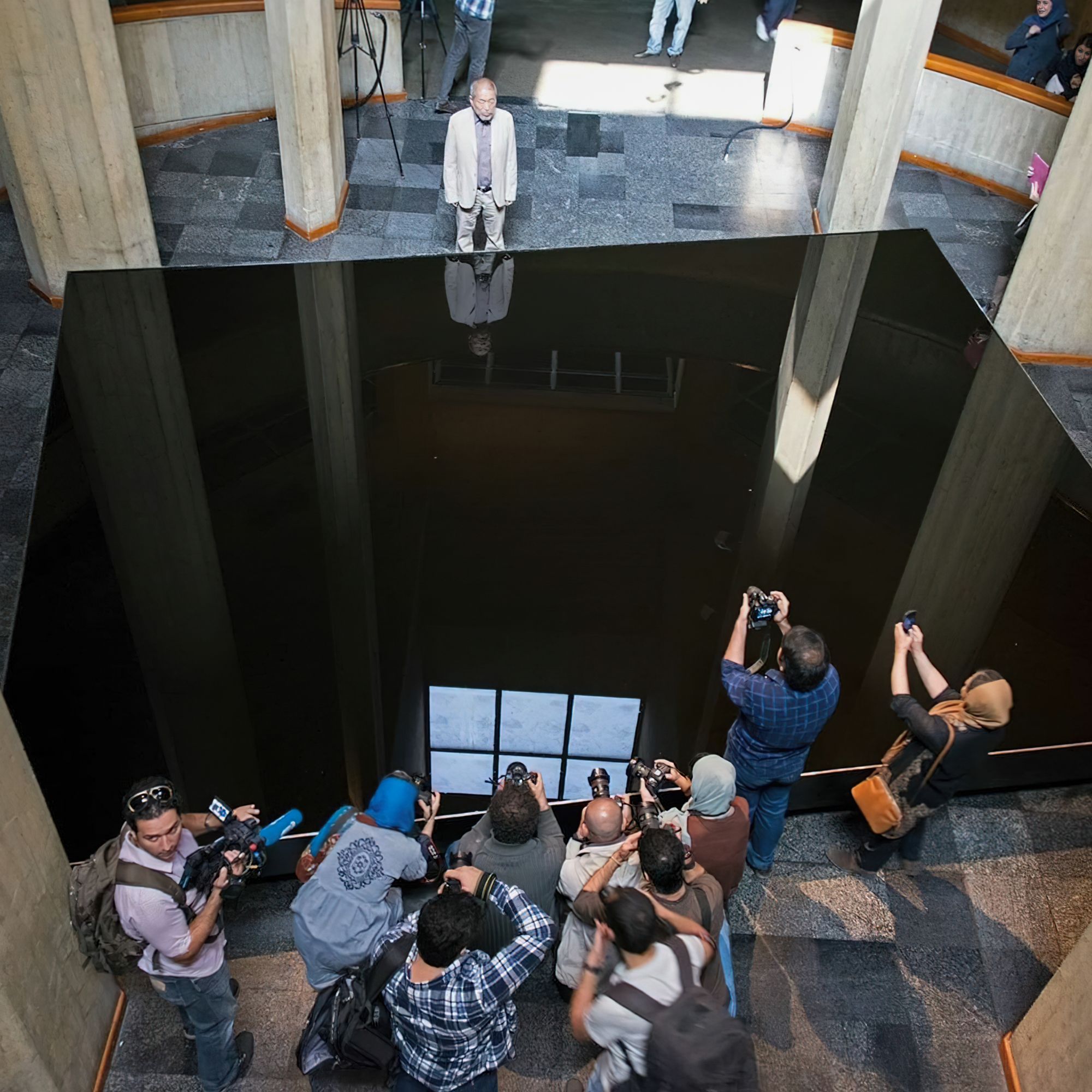 Noriyuki Haraguchi standing next to Matter and Mind (1977) at the Tehran Museum of Contemporary Art during his visit in 2017. Photo courtesy of the Tehran Museum of Contemporary Art.