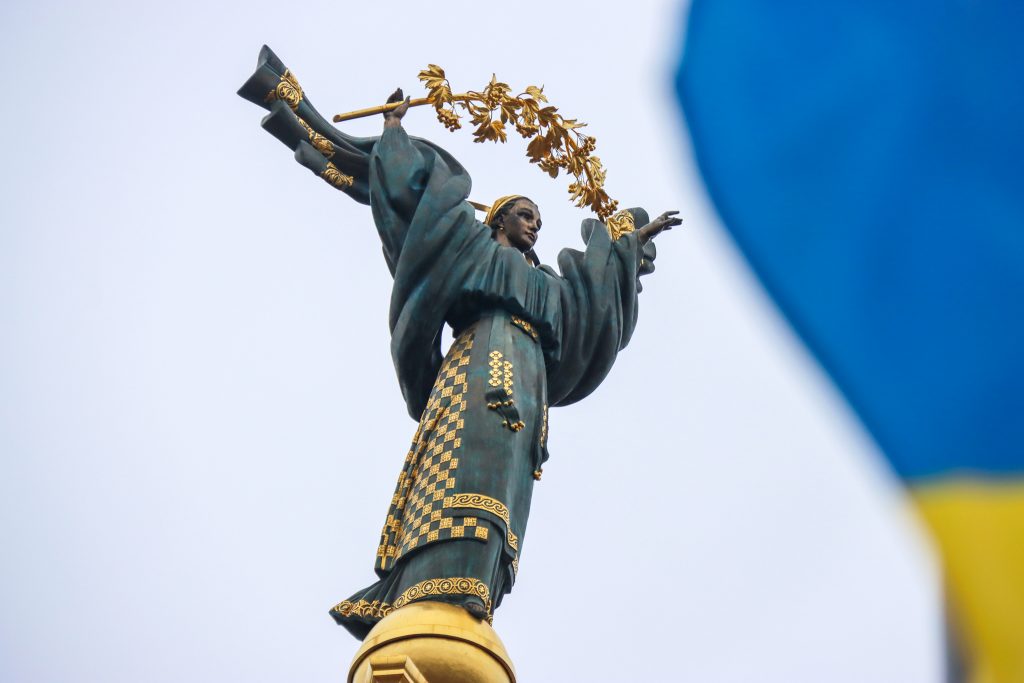 A Ukrainian flag flies before the Independence Monument in Independence Square, Kyiv. Photo: Anatolii Siryk/ Ukrinform/Future Publishing via Getty Images.