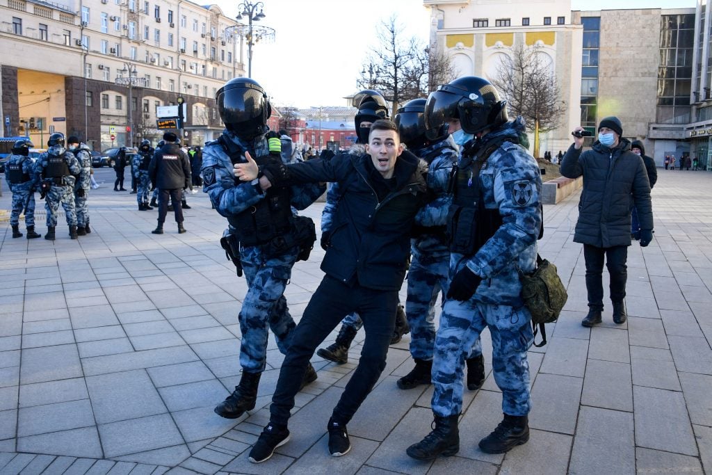 Police officers detain a man during a protest against Russia's invasion of Ukraine in central Moscow on February 27, 2022. Photo by Alexander Nemenov/AFP via Getty Images.