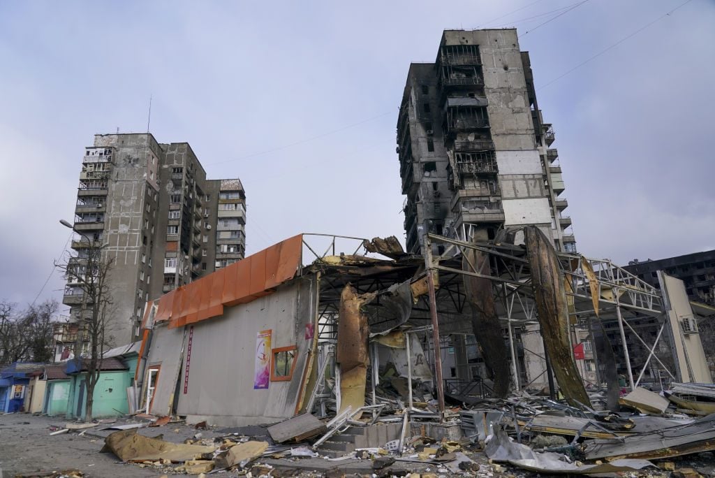 Destroyed buildings are seen as civilians trapped in Mariupol city under Russian attacks, are evacuated in groups under the control of pro-Russian separatists, through other cities, in Mariupol, Ukraine on March 18, 2022. Photo: Stringer/Anadolu Agency via Getty Images.