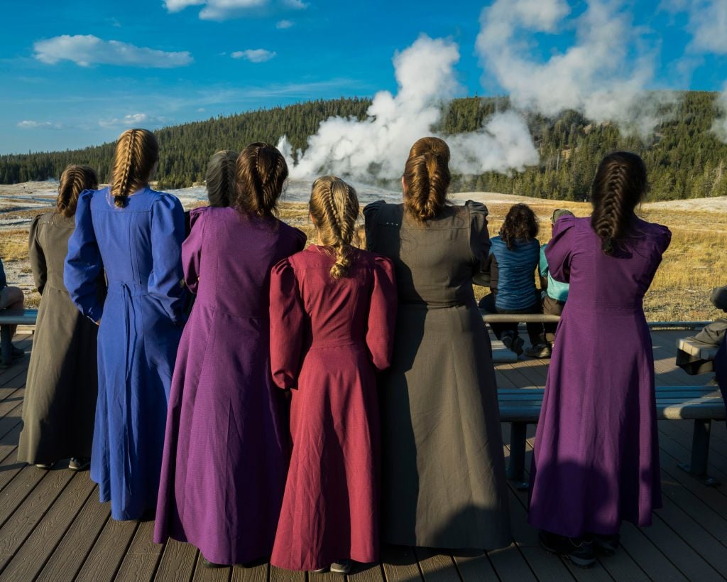 Fundamentalist Church of Jesus Christ of Latter-Day Saints members visiting Old Faithful at Yellowstone National Park. (Photo by: Visions of America/Joe Sohm/Universal Images Group via Getty Images)