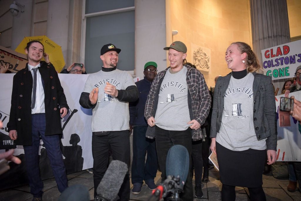 The "Colston Four"—Sage Willoughby, Jake Skuse, Milo Ponsford and Rhian Graham—celebrate after receiving a not guilty verdict at Bristol Crown Court, on January 5, 2022 in Bristol, England. (Photo by Finnbarr Webster/Getty Images)