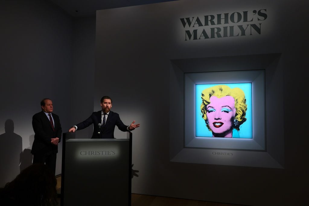 Christie’s Americas chairman Marc Porter looks on as Christie's chairman Alex Rotter announces the sale of Andy Warhol’s Shot Sage Blue Marilyn on March 21, 2022 in New York City. (Photo by Dia Dipasupil/Getty Images)