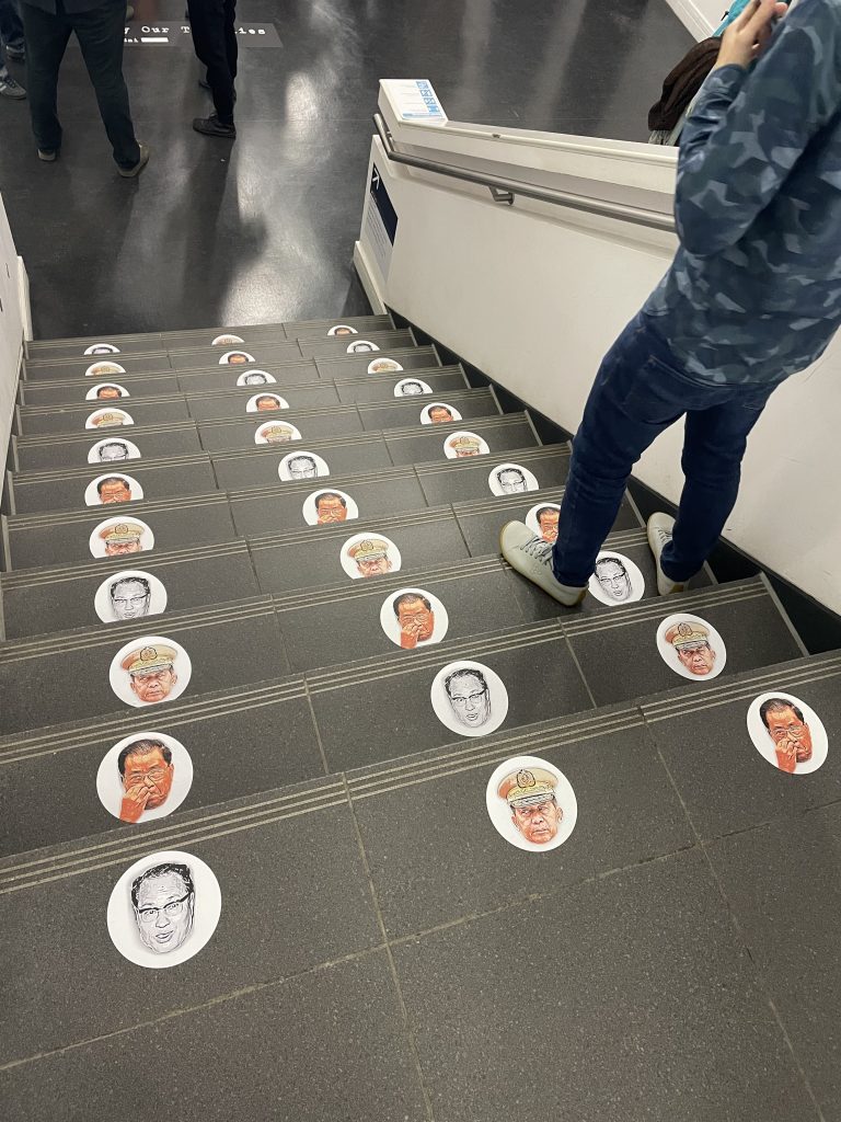 Faces of the dictators on the floor. Photo by Vivienne Chow. 