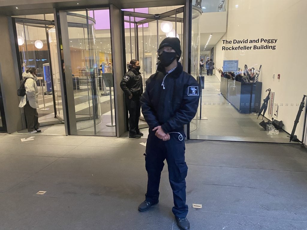 Security outside New York's Museum of Modern Art after a stabbing on the premises. Guests left umbrellas behind during the emergency evacuation that followed. Photo by Sarah Cascone.