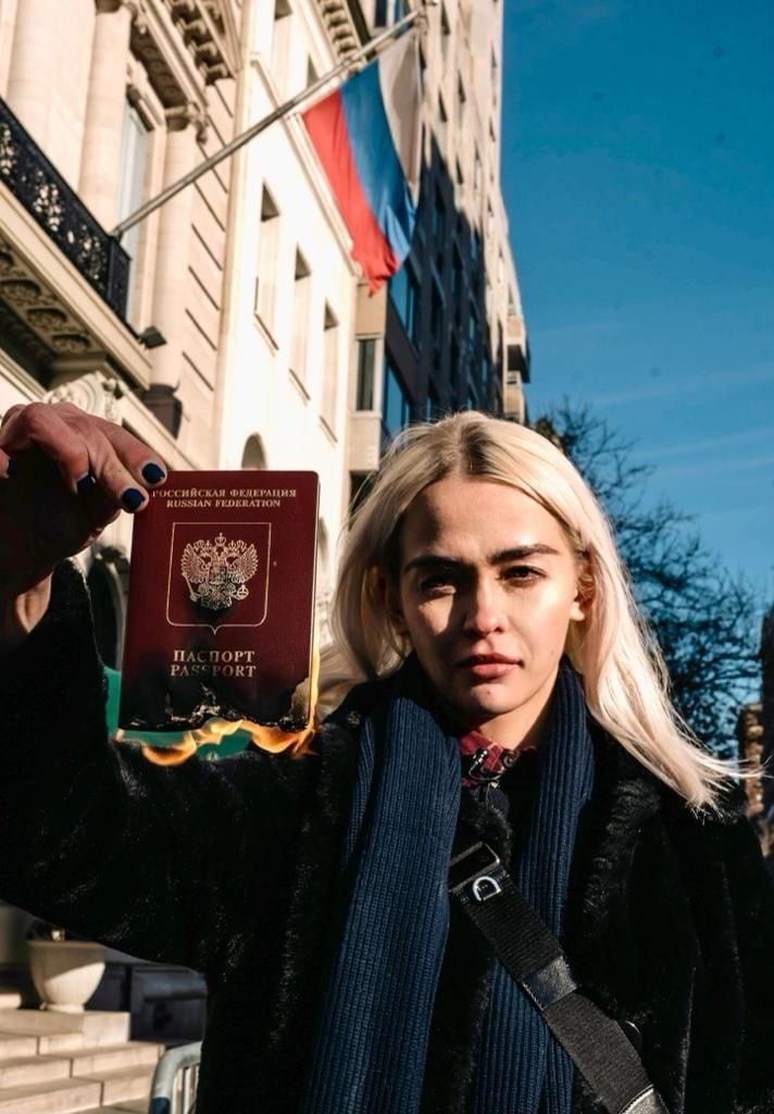 Olive Allen burning her Russian passport in front of the Russian embassy in New York. Photo credit: NFT Now.