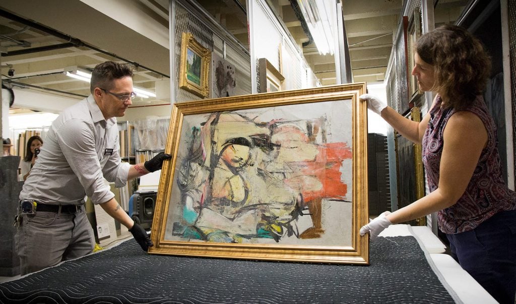 University of Arizona staff at the inspection and authentication of the recovered Willem de Kooning painting Woman-Ochre (1954–55), ©the Willem de Kooning Foundation/Artists Rights Society (ARS), New York. Photo by Bob Demers/UANews, courtesy of the University of Arizona Museum of Art.