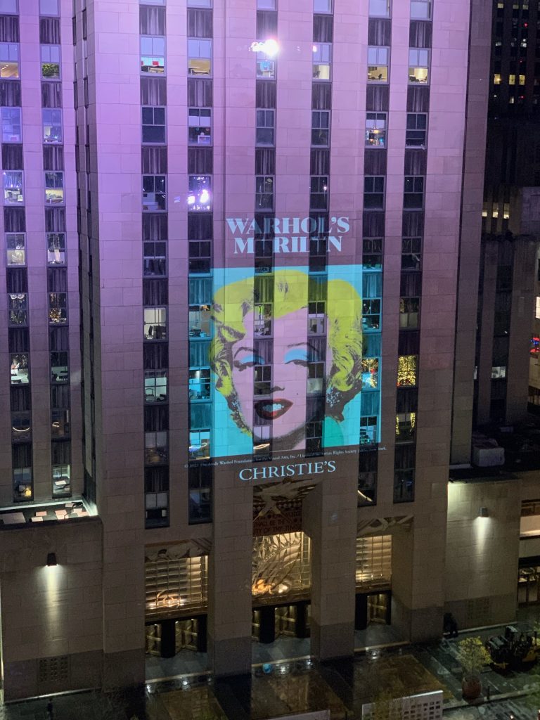 The projection of Andy Warhol's Shot Sage Blue Marilyn (1964) on Rockefeller Center. Courtesy of Christie's.