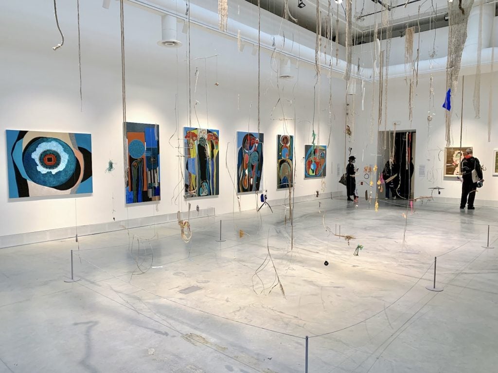 Foreground: Cecilia Vicuña, <em>NAUfraga (2022)</em>; Background: paintings by Merikokeb Berhanu. Photo by Ben Davis.