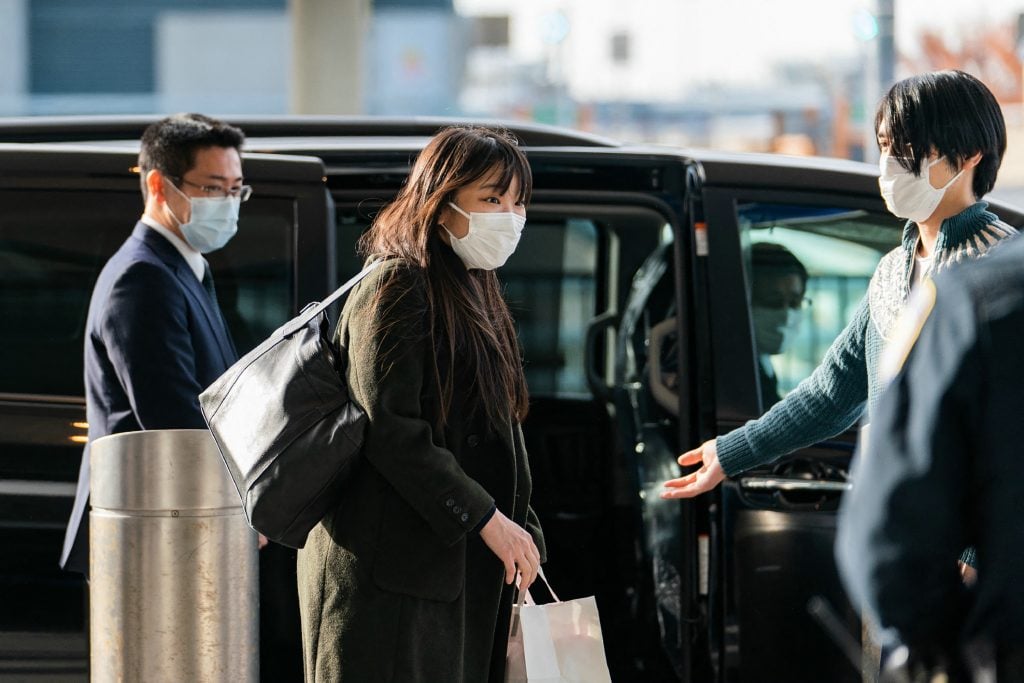 Japan's former Princess Mako, now Mako Komuro, and her husband Kei Komuro leave JFK International Airport in New York on November 14, 2021, following their arrival from Tokyo. Photo by Japan Pool/JIJI Press/AFP/ Japan Out via Getty Images.
