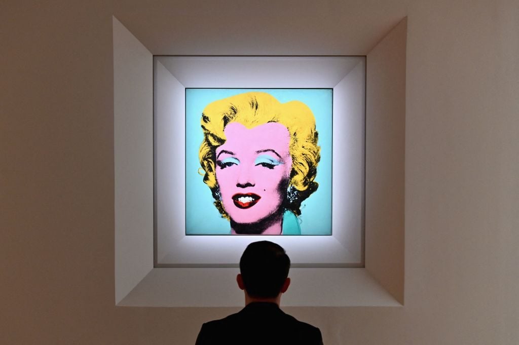 A man looks at Andy Warhol's Shot Sage Blue Marilyn during Christie's 20th and 21st Century art press preview at Christie's New York on April 29, 2022 in New York City. (Photo by Angela Weiss / AFP) (Photo by ANGELA WEISS/AFP via Getty Images)