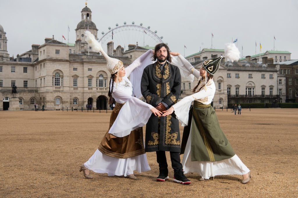 Artist Firouz Farman-Farmaian with Republic of Kyrgyz Pavillion Dancers at Horse Guards Parade to mark the London launch of the first year of Central Asian nation entering the Venice Biennale. Photo by Ki Price/Getty Images.