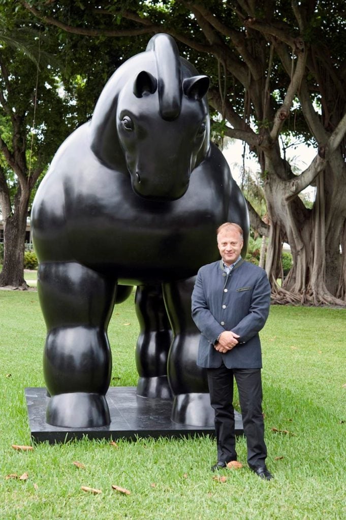 Felipe Grimberg with a sculpture by Fernando Botero.