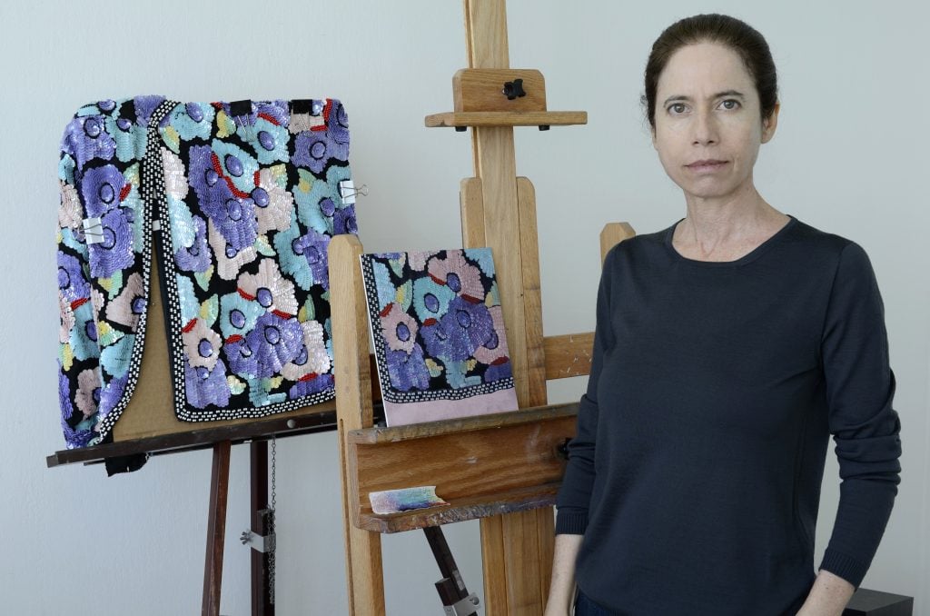 The painter Victoria Gitman in her Miami studio working on one of her latest paintings, a series depicting sequins jackets, dresses, and tops. As always, the artist works directly from life. Photograph courtesy the artist.