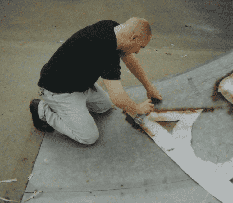 William Gannon spray painting in his younger days. Photo courtesy of the artist. 